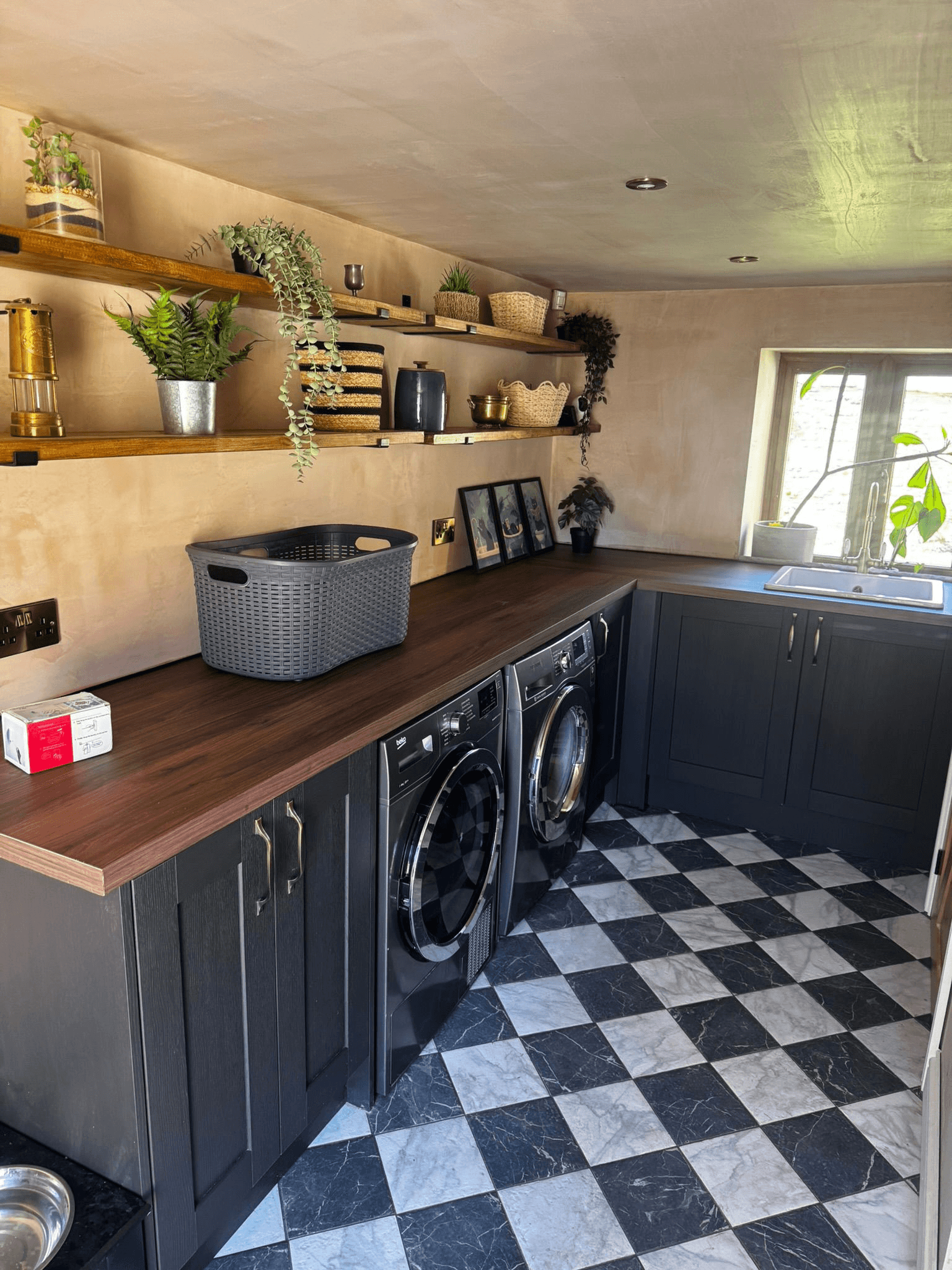 Utility laundry room with dark grey cabinets and checkered floor